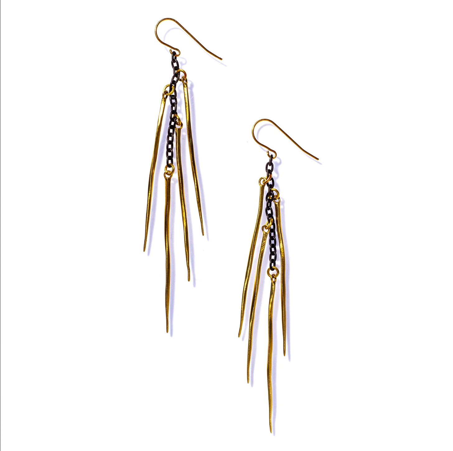 Gold and black earrings with dangling elements on a white background