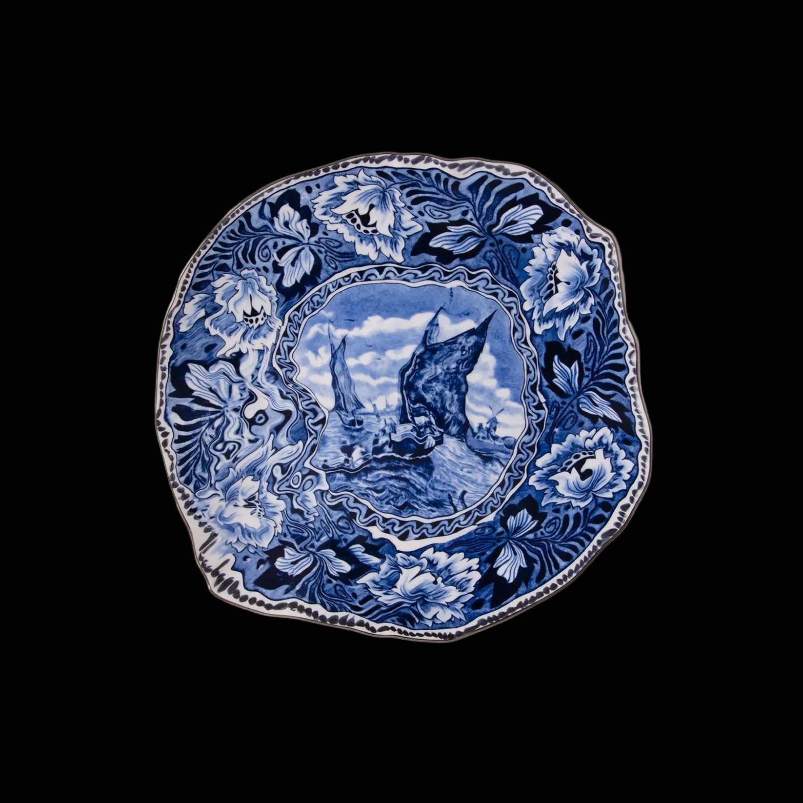 Blue and white decorative plate with nature scene on a white background
