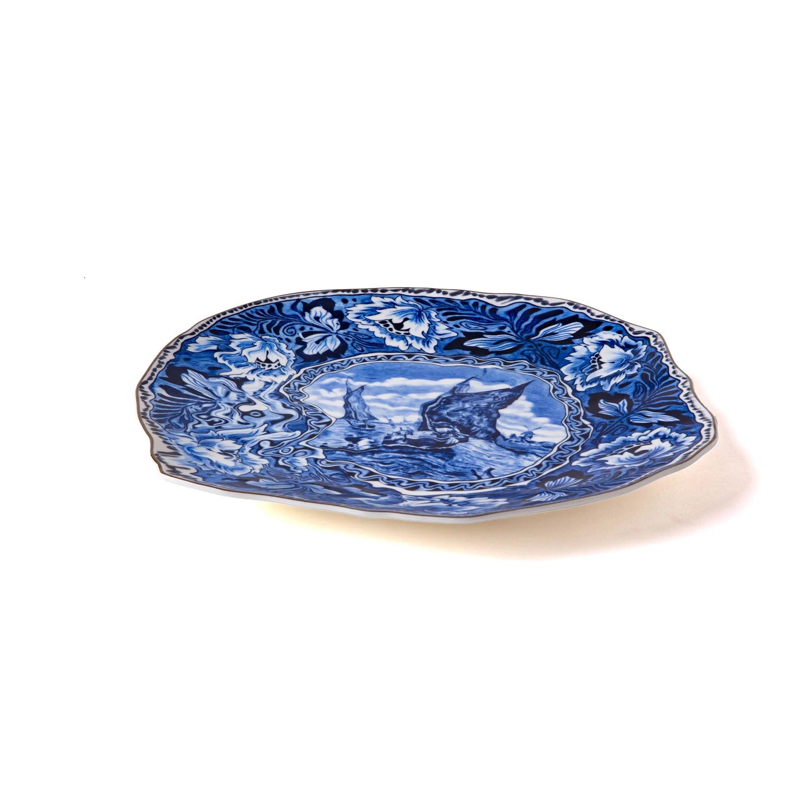 Decorative blue and white plate with intricate patterns on a white background