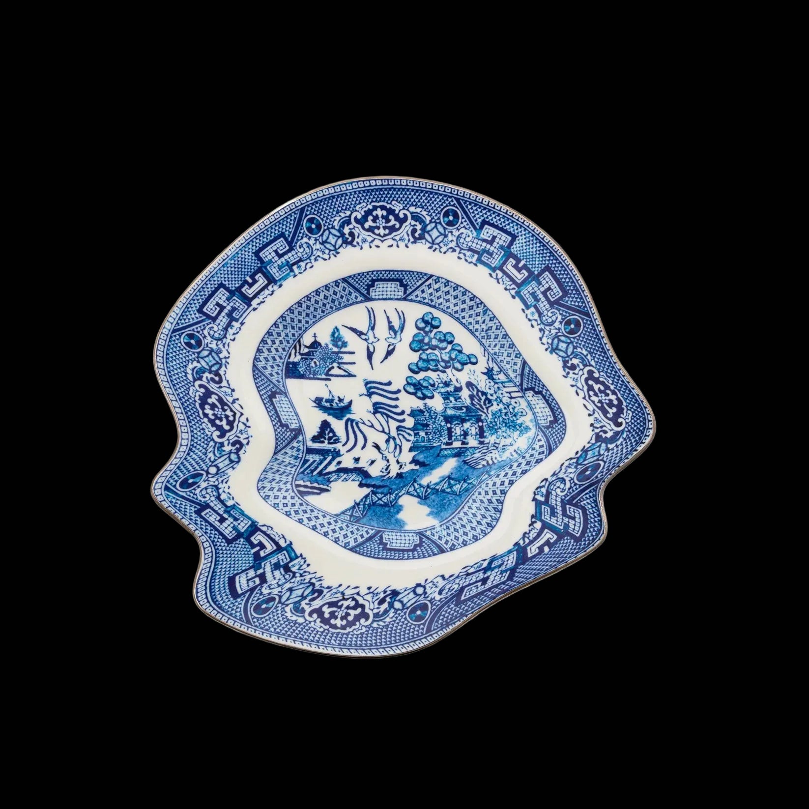 Blue and white decorative plate with intricate patterns on a white background
