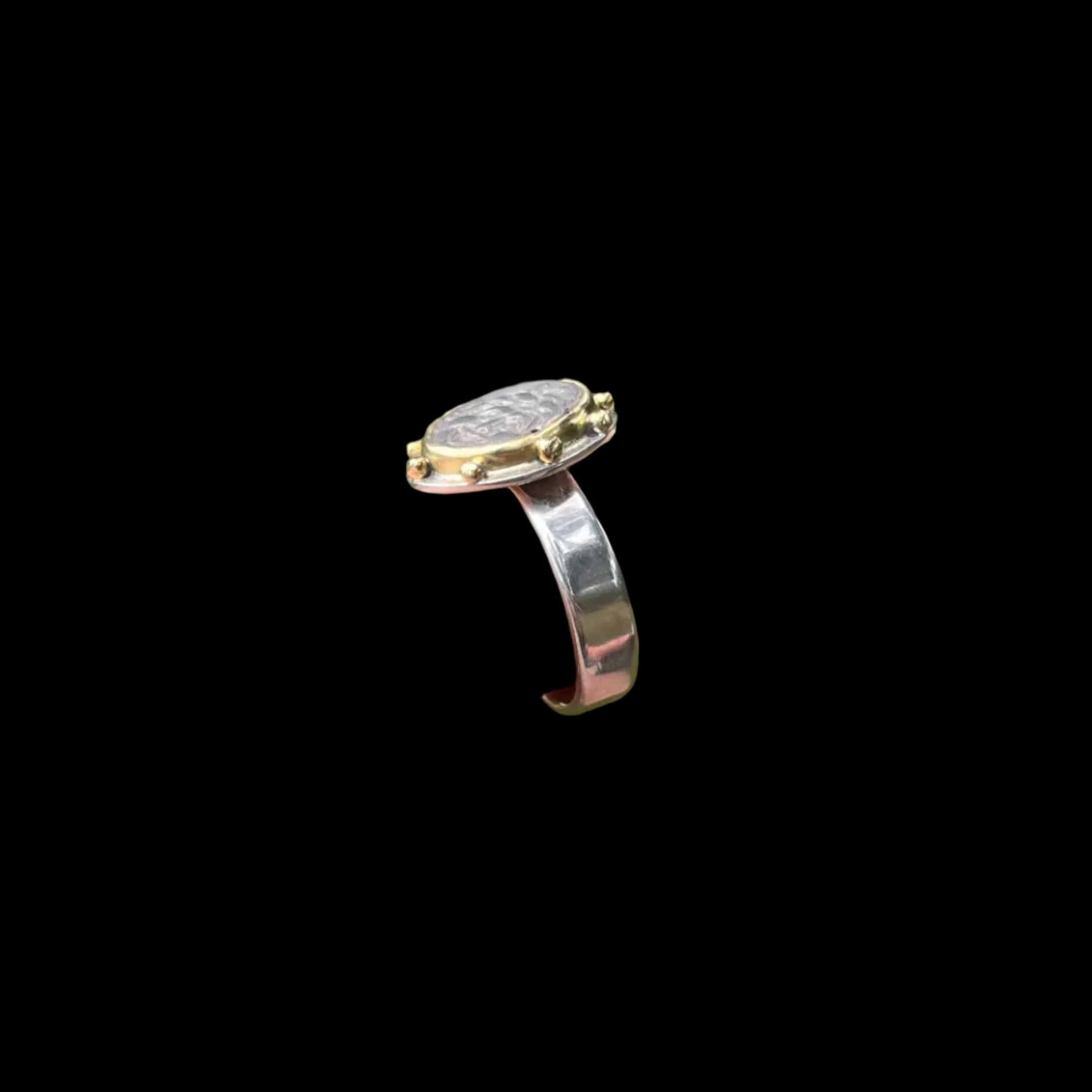 Side view of a flat ring and narrow silver band
