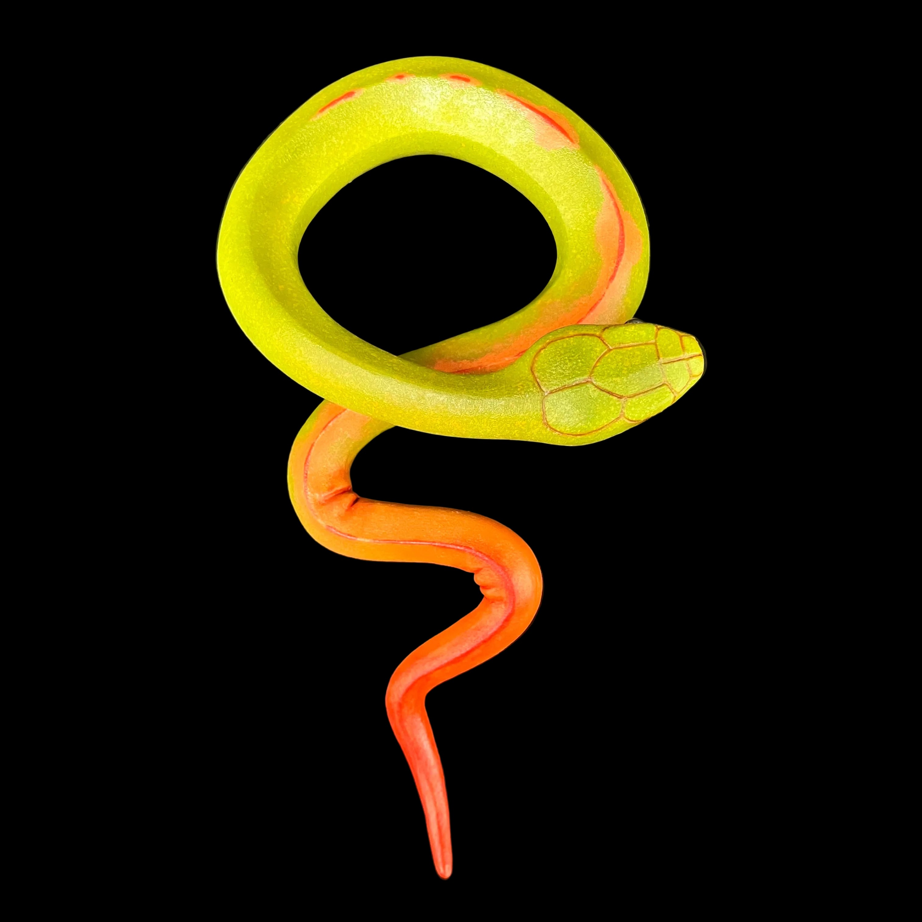 Sculpted snake with green and orange colors on a black background