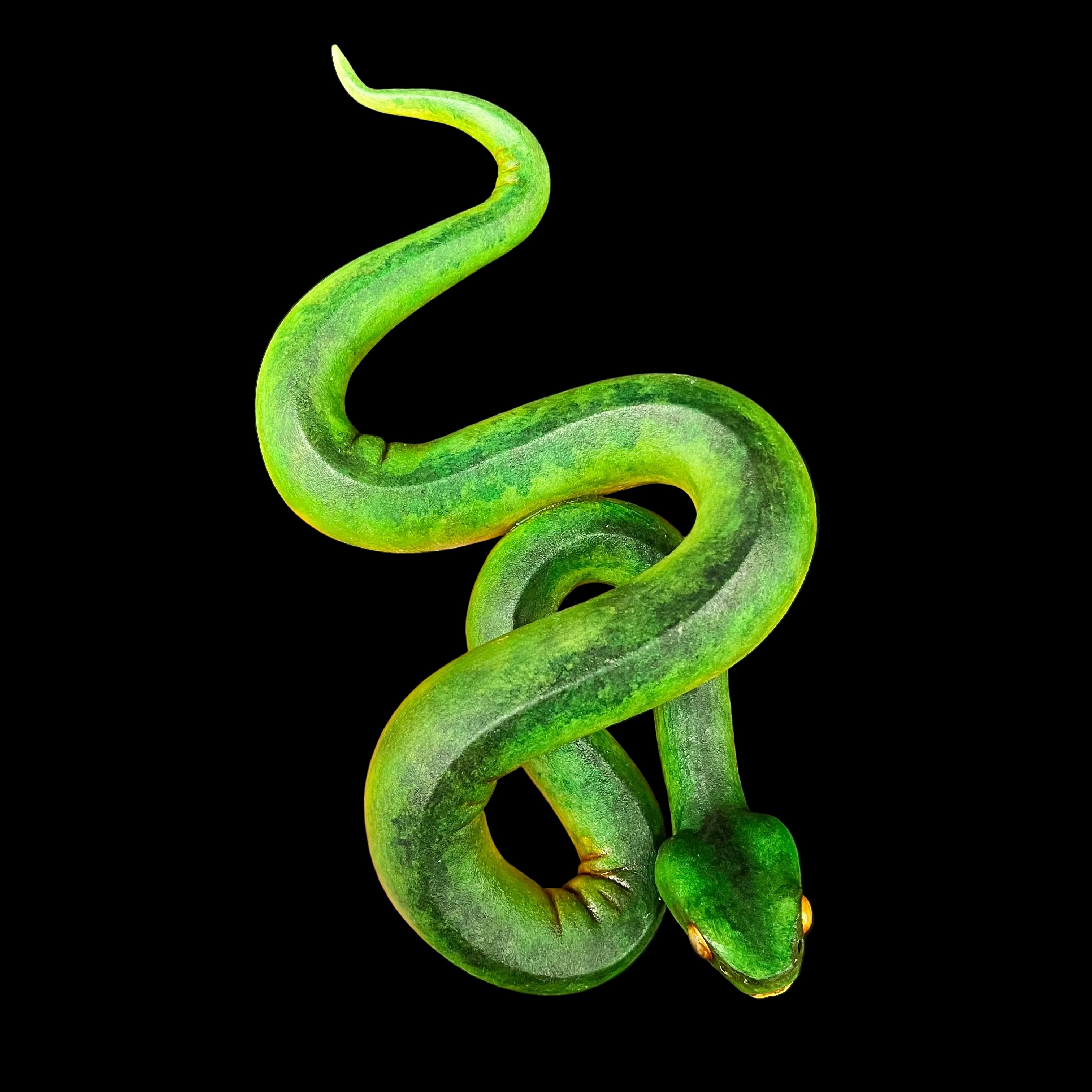 Green snake toy held in a hand against a black background