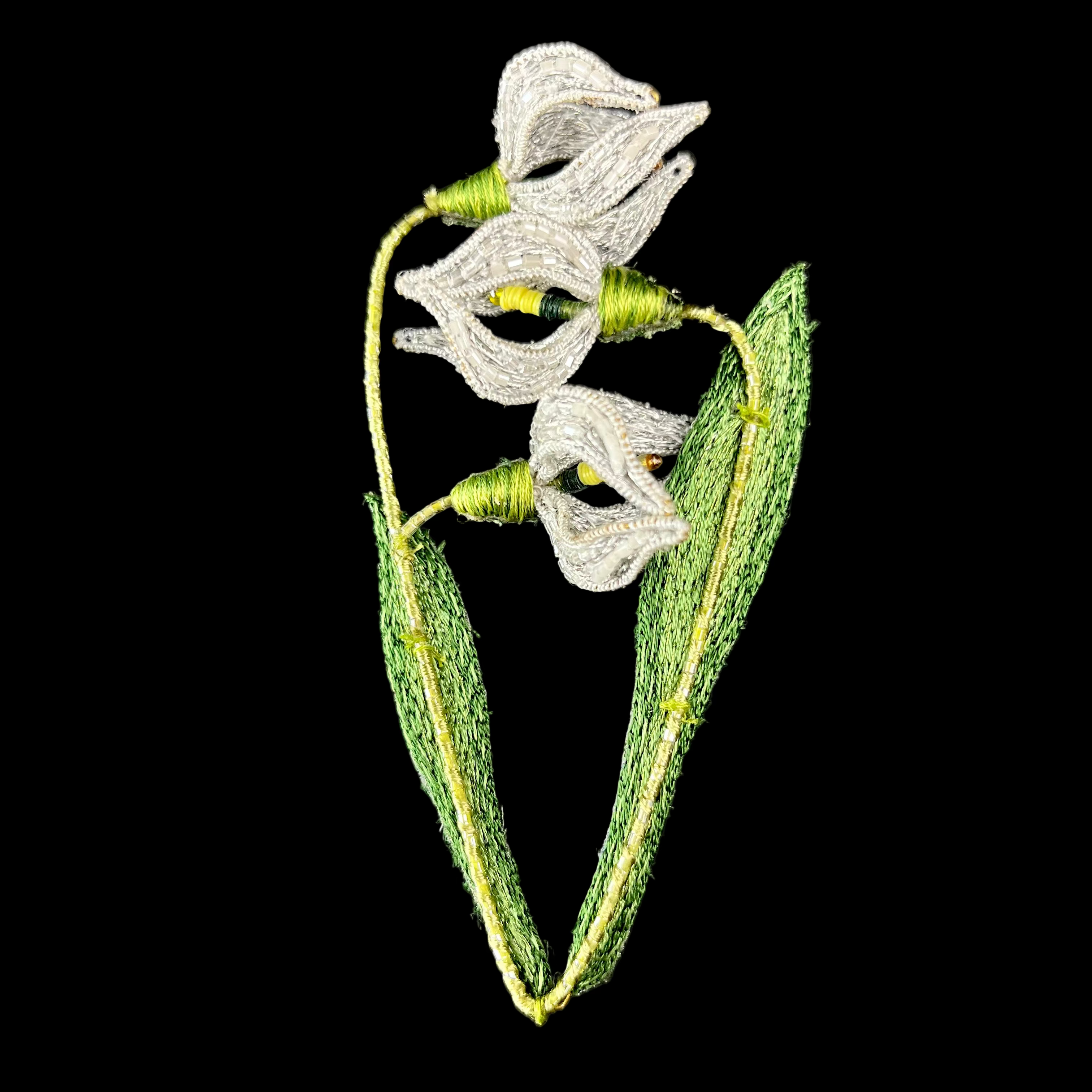 Embroidered flower design on fabric with a black background