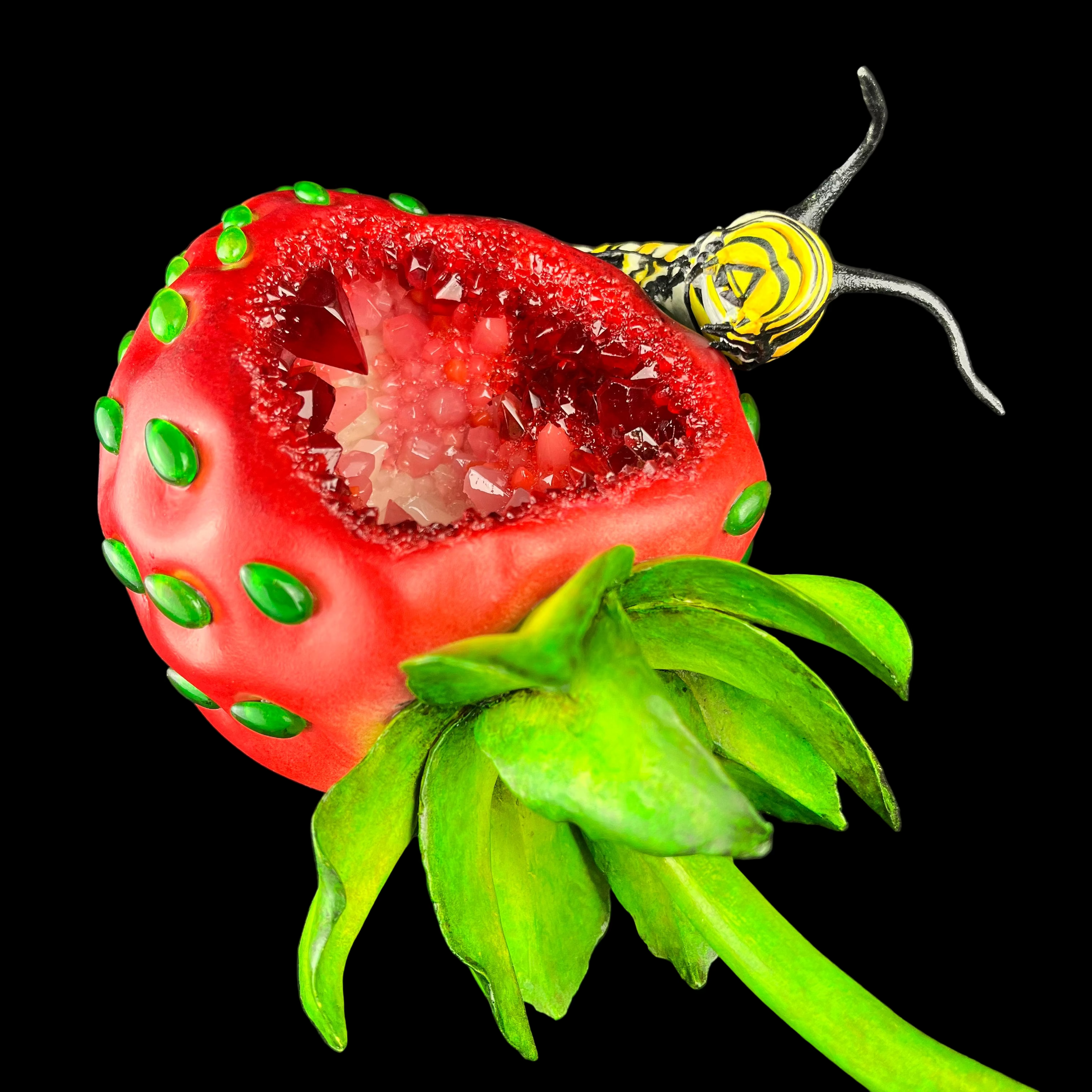 Strawberry-shaped object with a yellow bee on a dark background