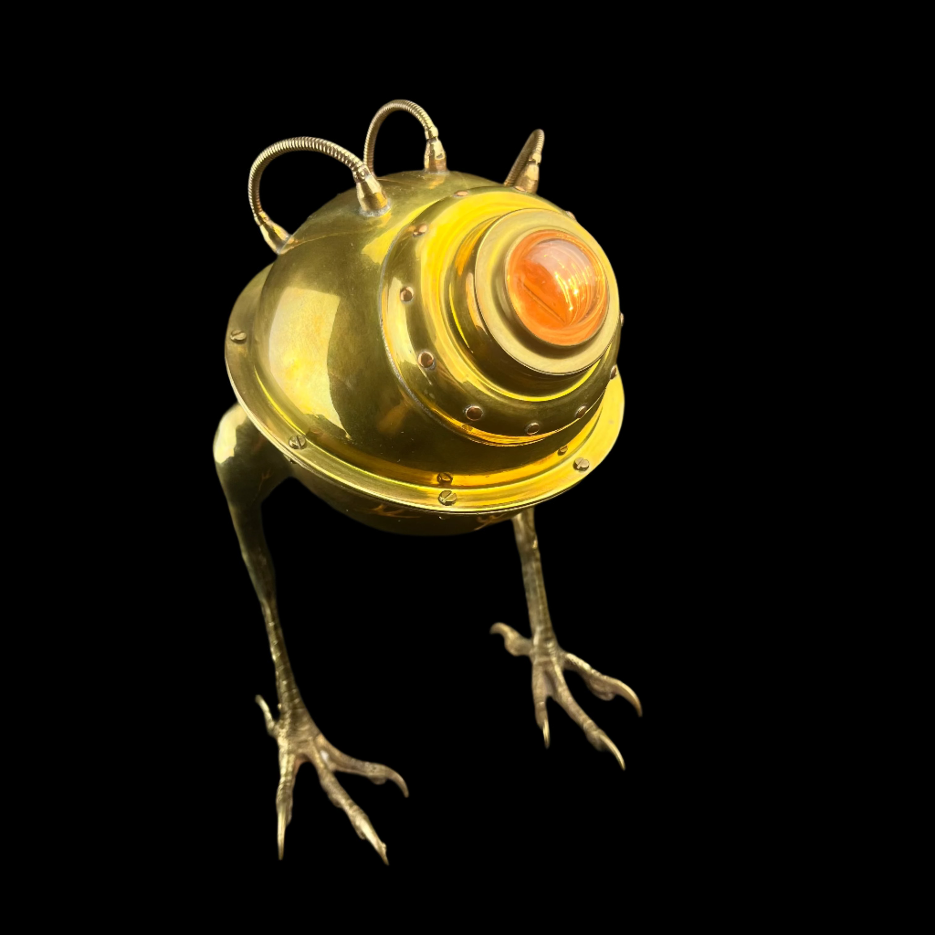 Metallic creature figurine with a glowing orange eye on a dark background