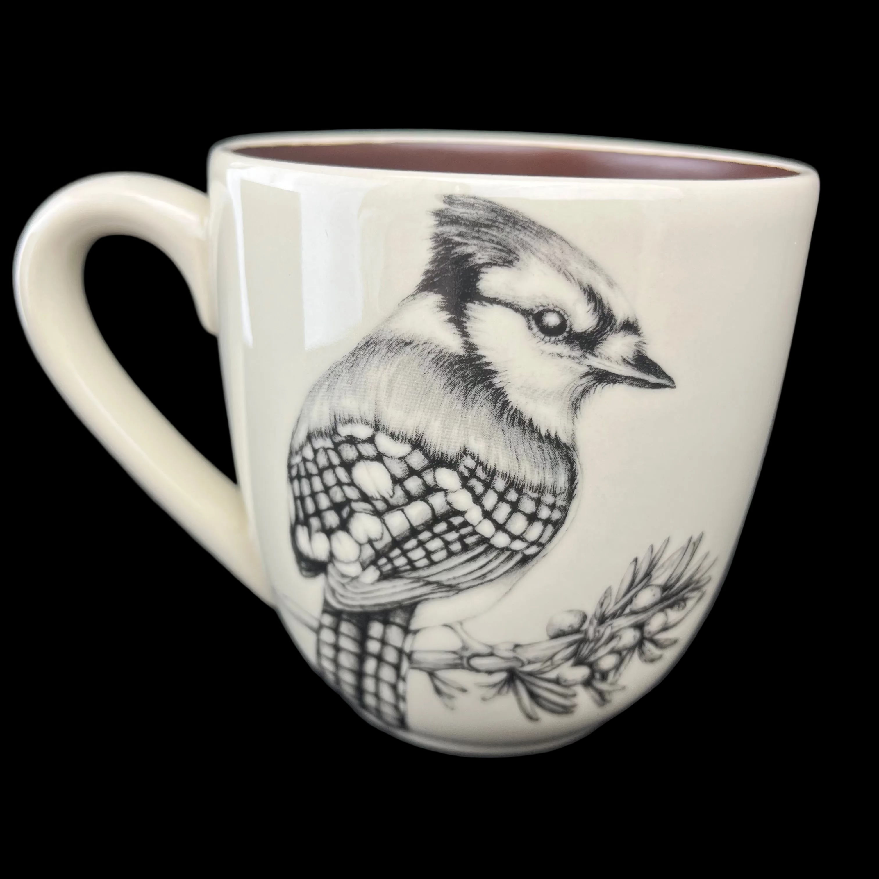White mug with black and white bird illustration on a dark background