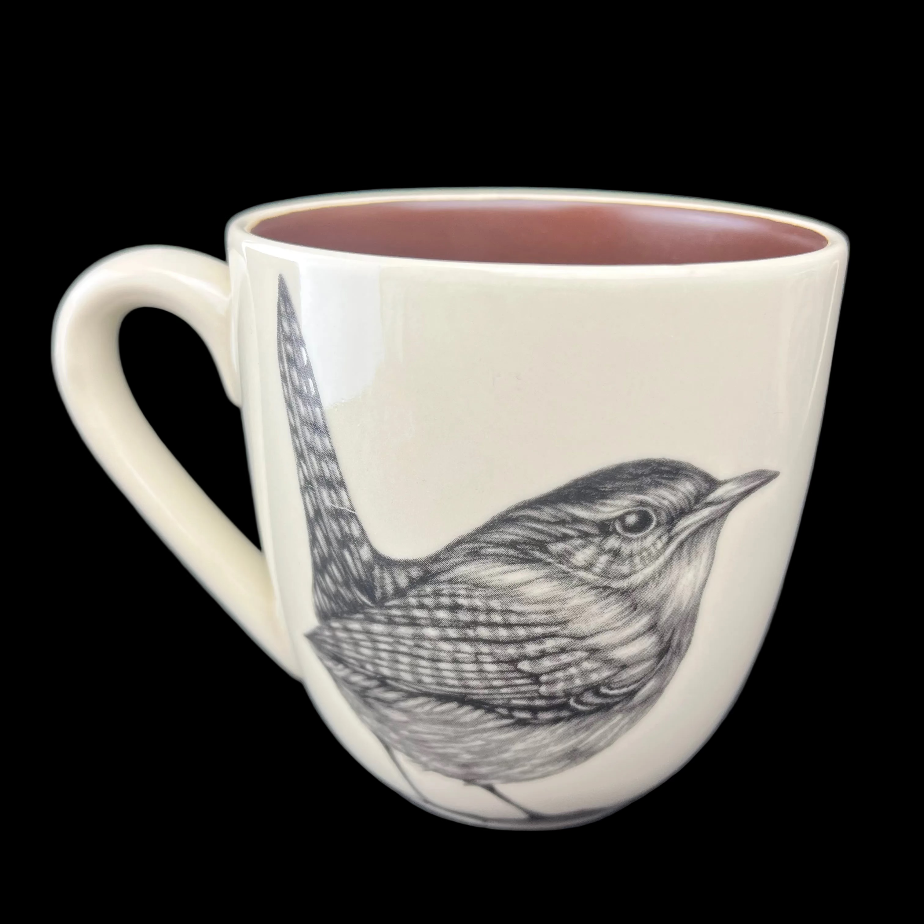 Mug with a bird illustration on a dark surface