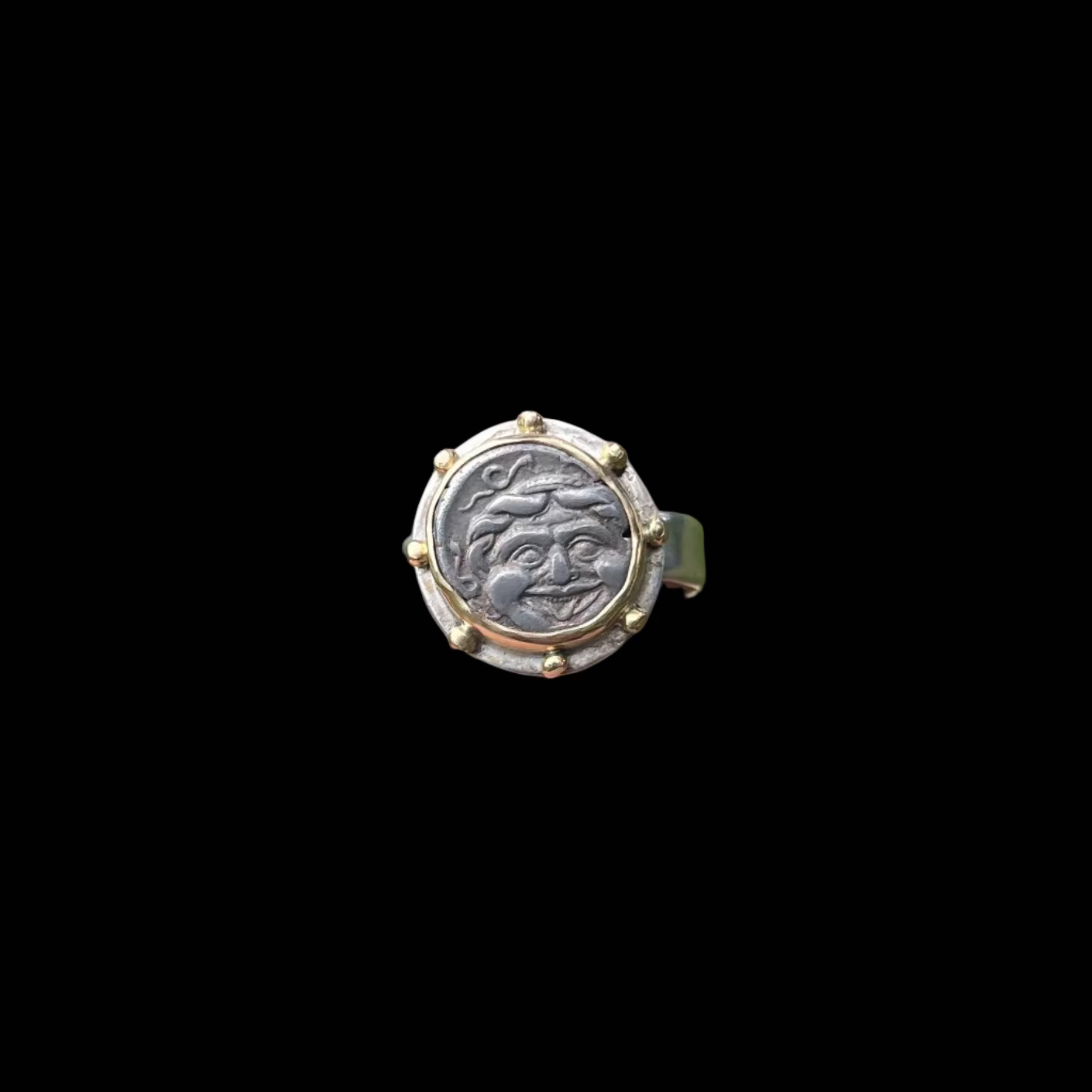 A decorative ring with a face design.
