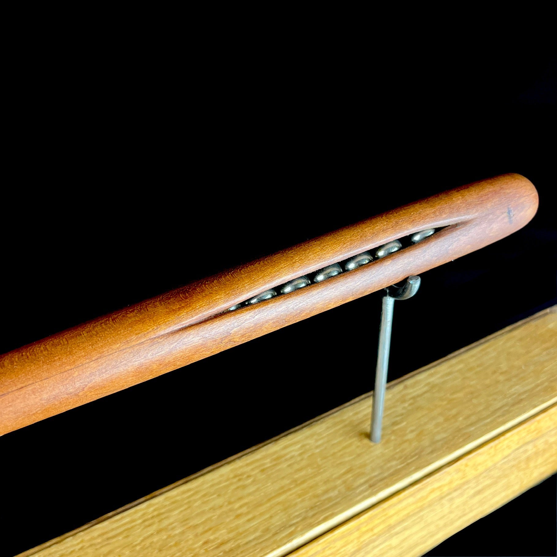 Close detail of silver spheres inside of wand handle