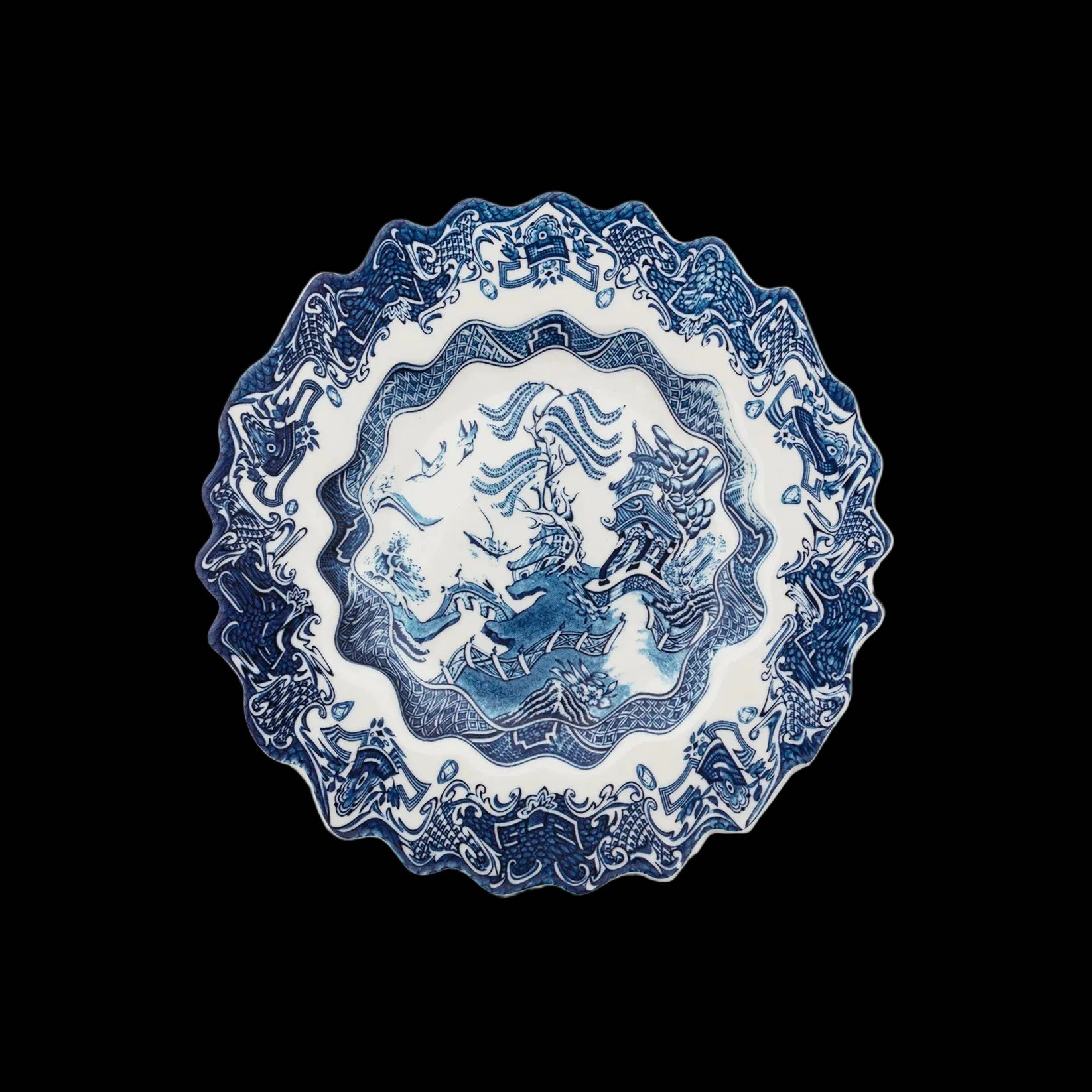 Blue and white decorative plate with intricate patterns on a white background