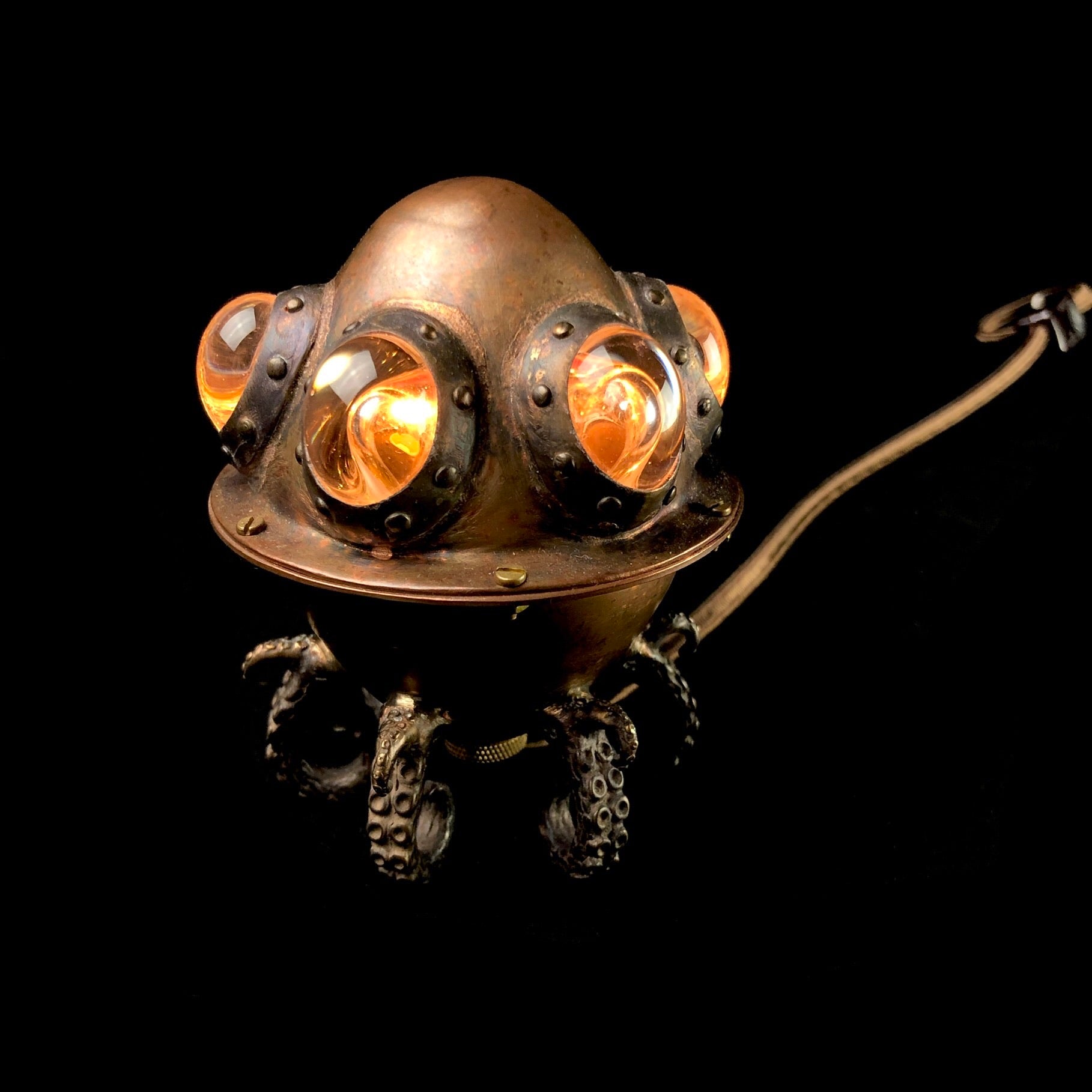 Copper Lamp with glass accents and tentacles on black background