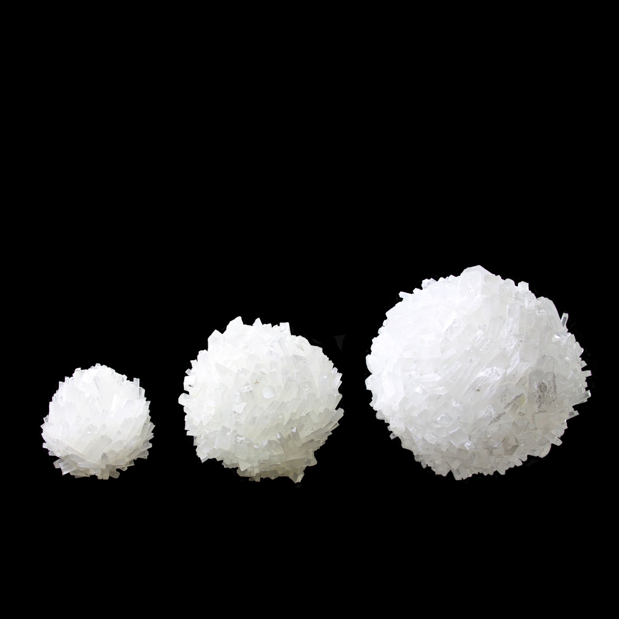 Side view of three White Glass Sphere options in order from left to right Mini, Small and Medium