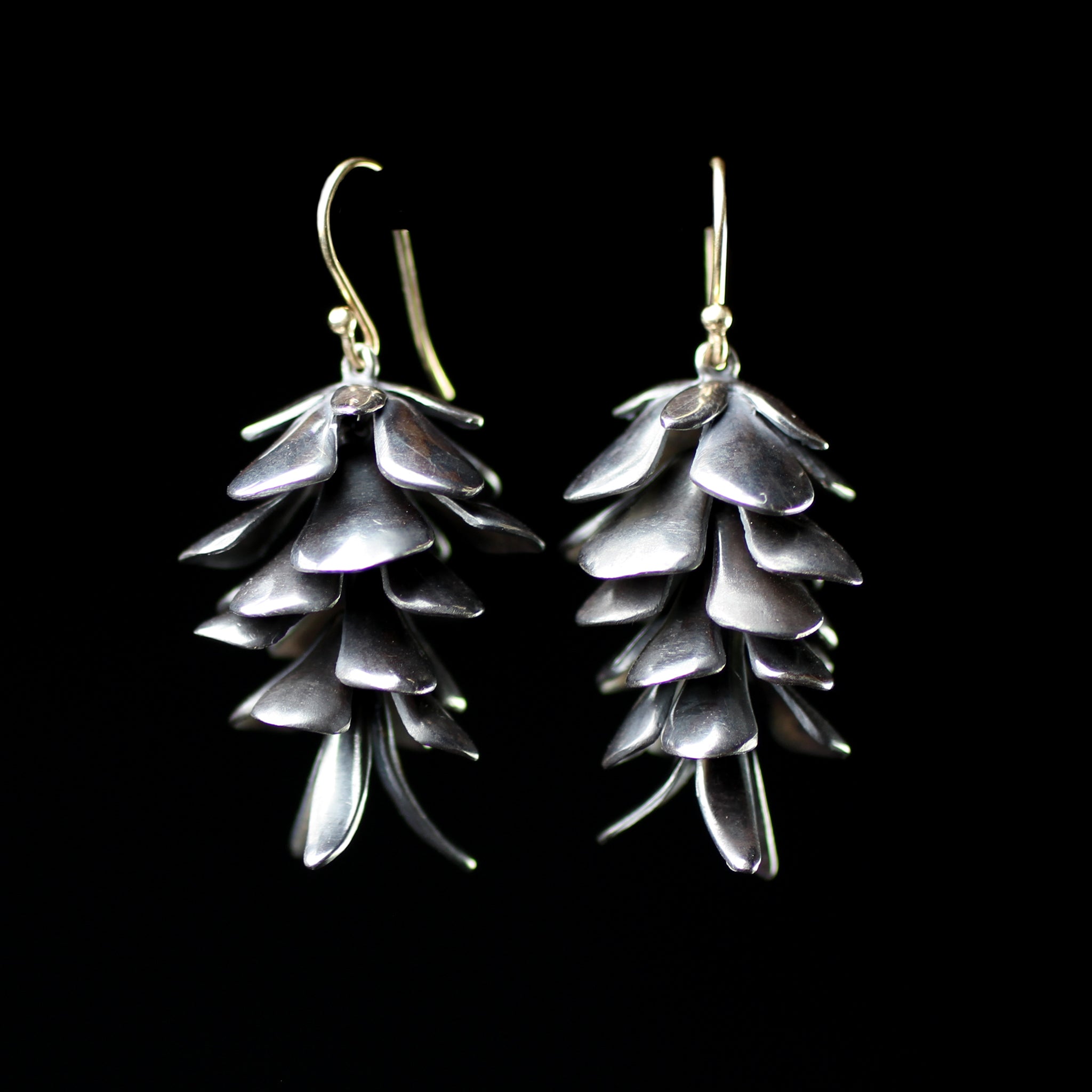 Oxideized sterling silver articulatec pine cone earrings desinged by fine jeweler Annette Ferdinandsen