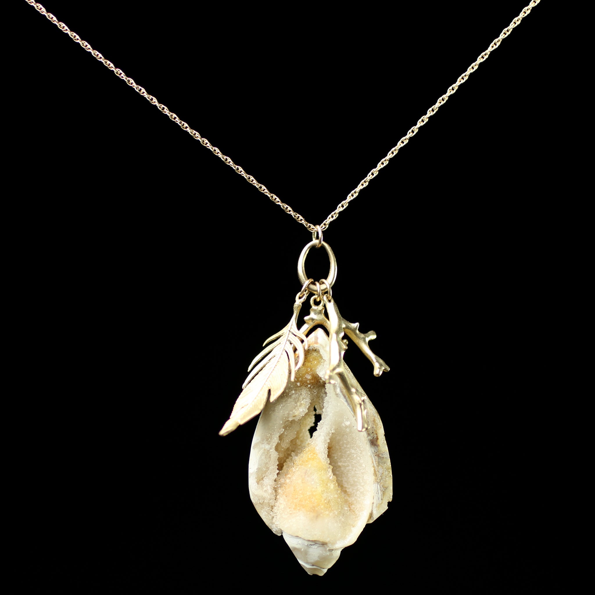 Front view of Beach Scavenger Necklace with shell pendant hanging on chain
