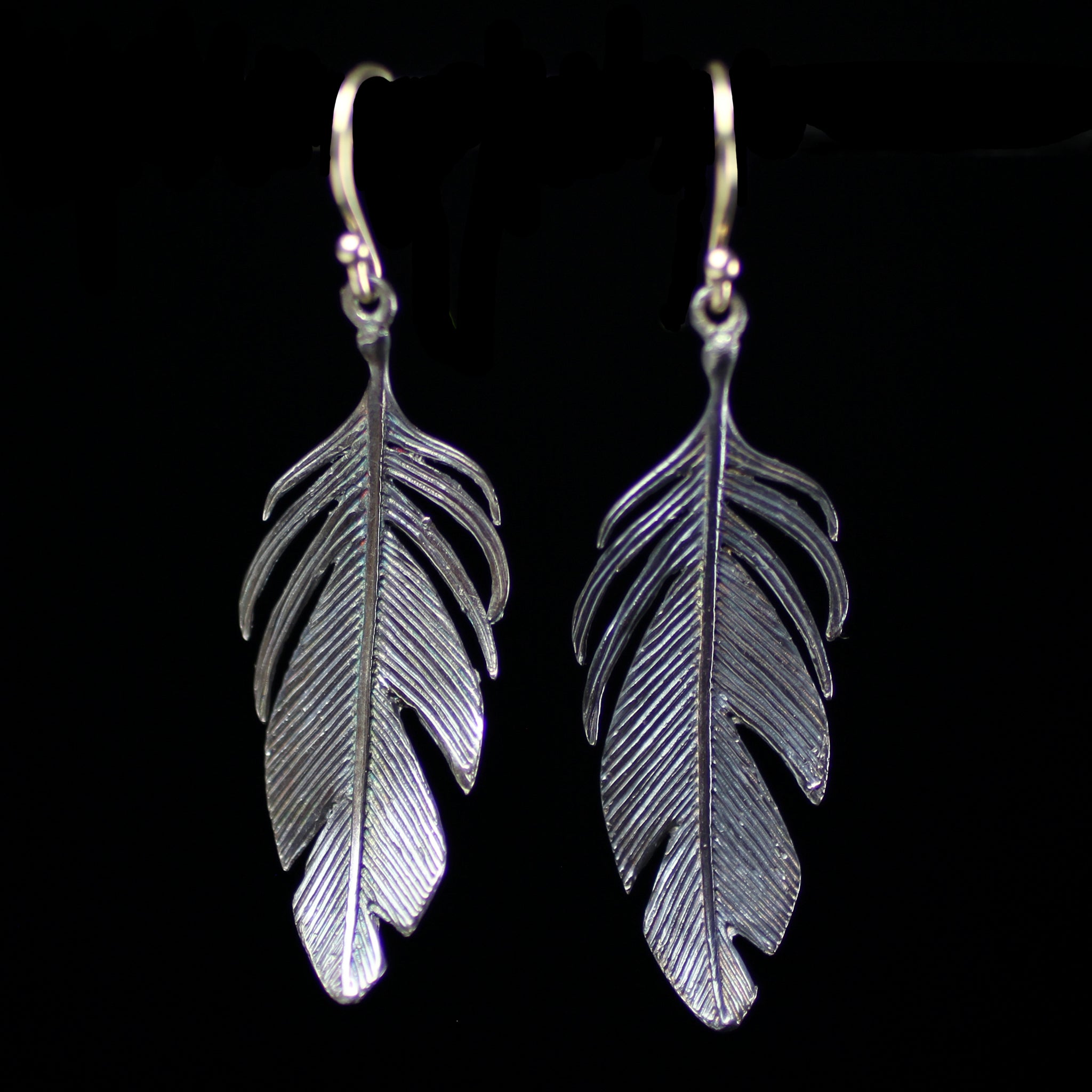 Sterling silver feather earrings hand made by fine jewelry designer Annette Ferdinandsen