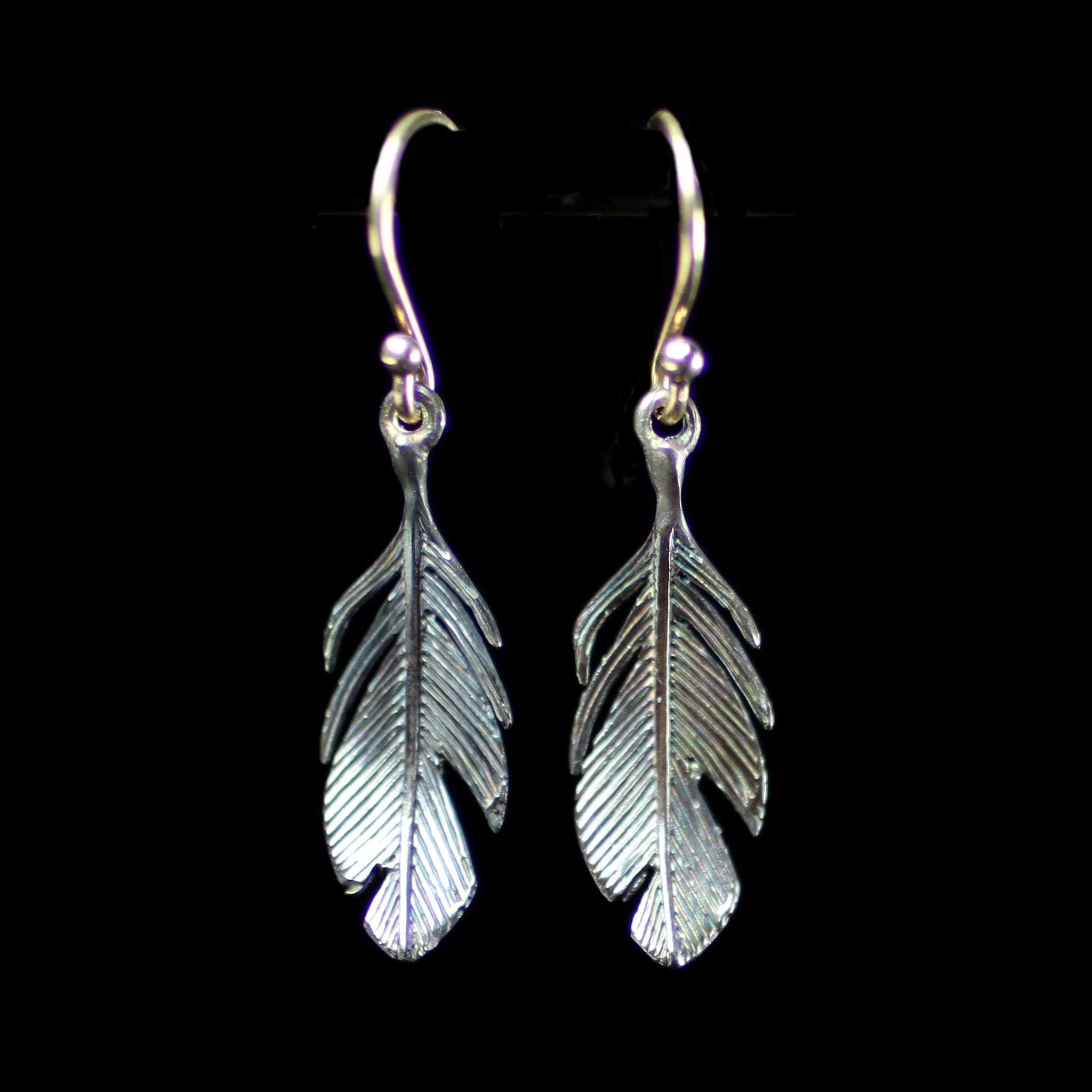 Sterling silver feather earrings hand made by fine jewelry designer Annette Ferdinandsen