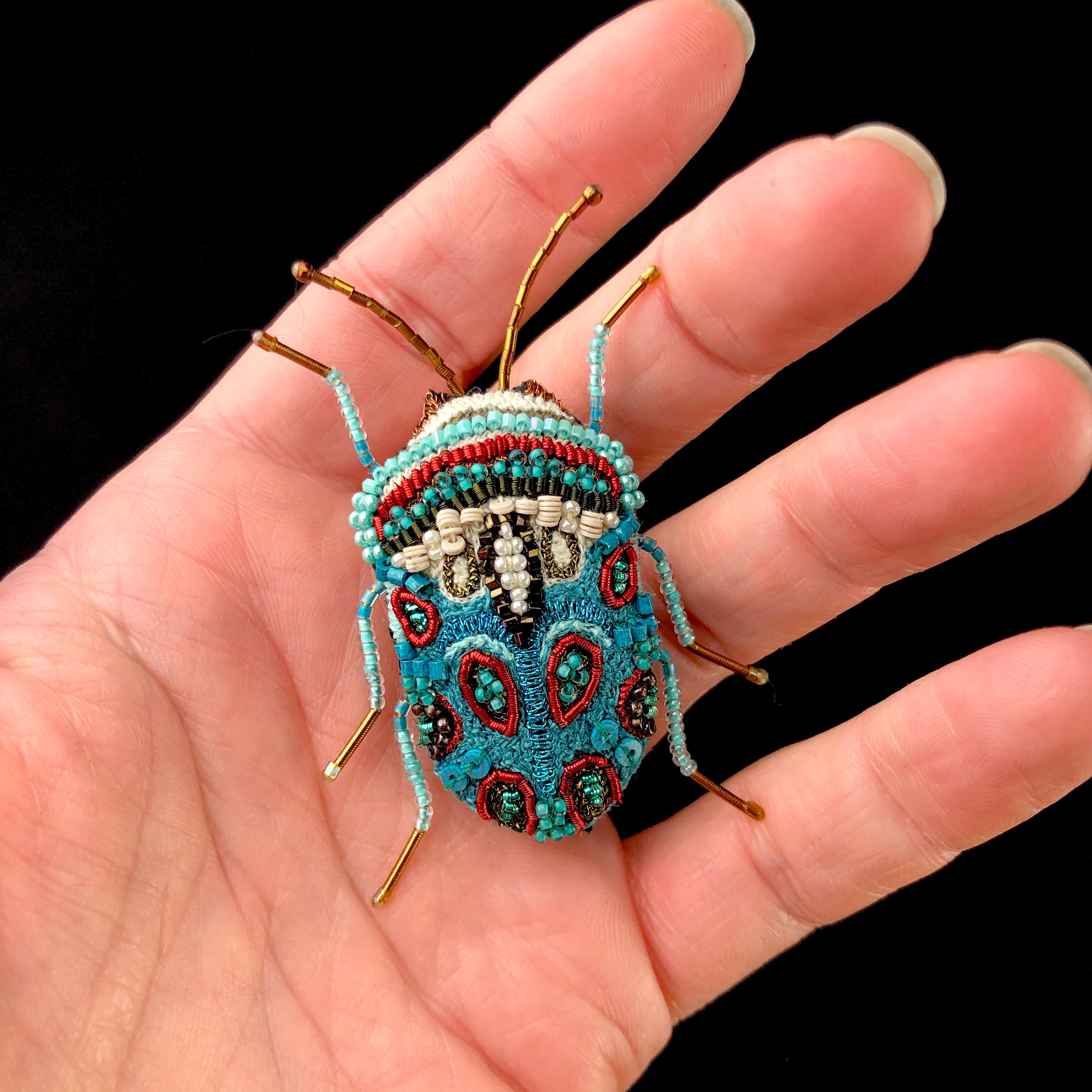 Picasso Bug Brooch Pin in hand for size reference