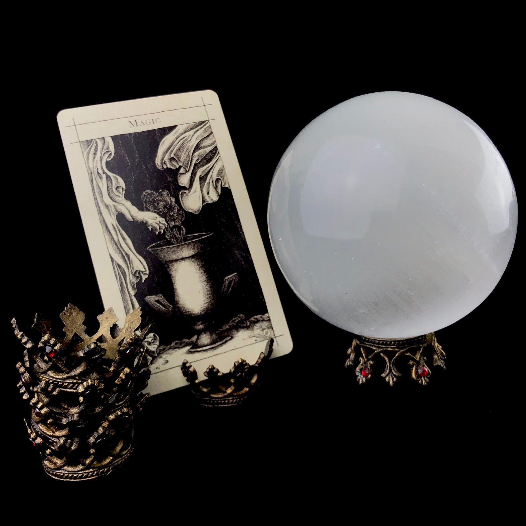 Collection of Mini Crowns shown in a stack, as a card holder with a Supra tarot, and used as a stand/pedestal holding a Selenite Orb