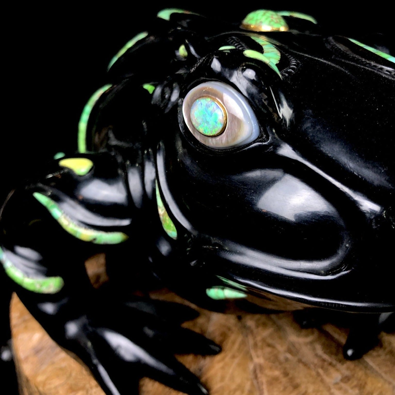 Detail of opal stone and abalone shell eye of Jet Frog Sculpture