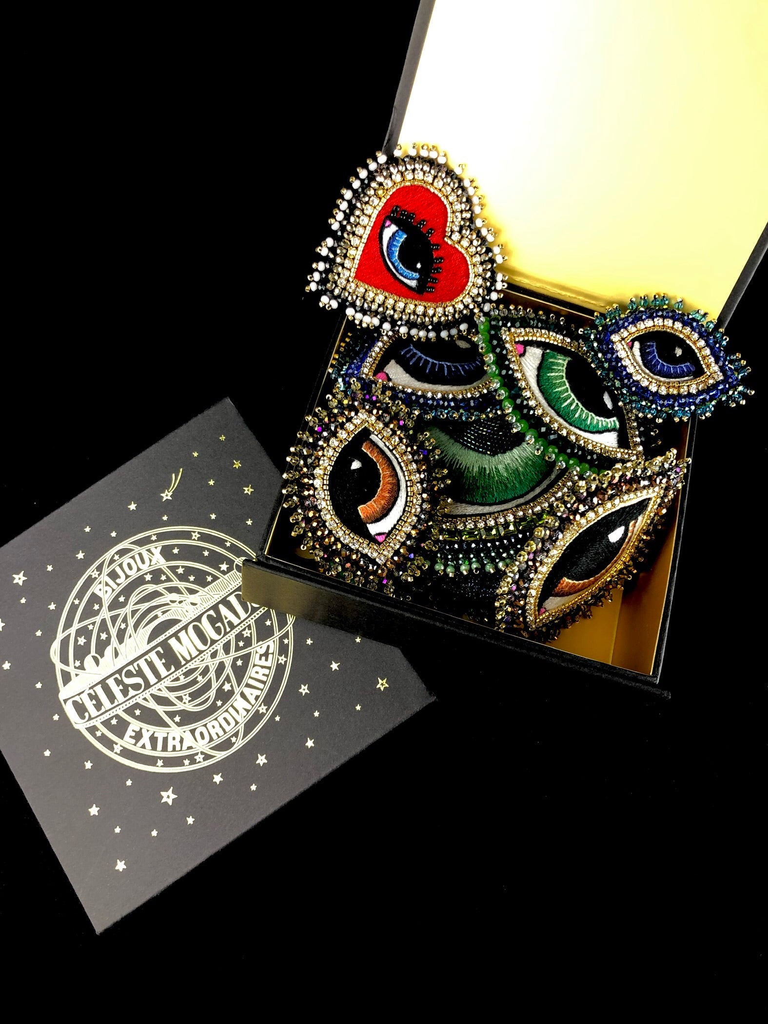 A collection of Celeste Mogador brooches shown in designer's packaging