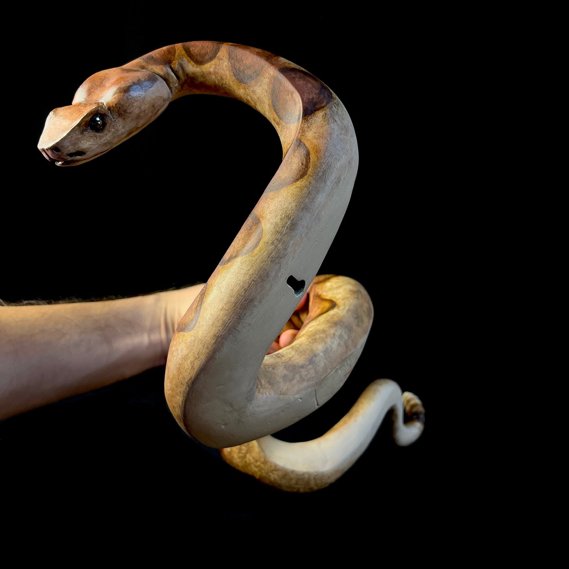 Back view of snake sculpture showing wall hanging apparatus and depth 