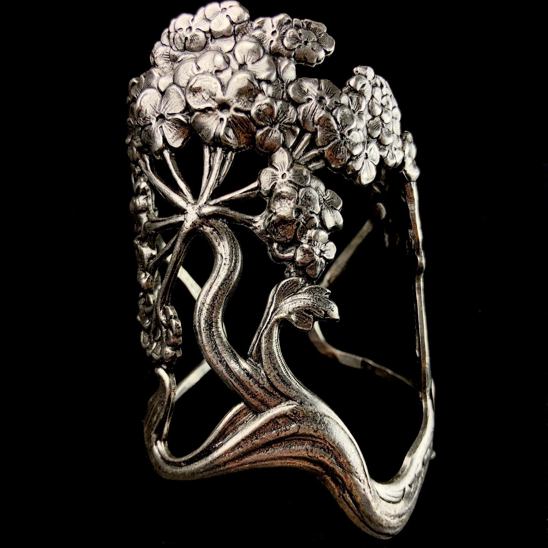 Detailed relief of Wisteria flower and branch creating cuff of bracelet